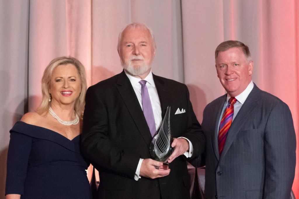 Luncheon Chairs Mary T. O'Connor and Mark C. Thompson pose with Jeffrey J. Bentley and his 2018 Nonprofit Professional of the Year award   |   J Robert Schraeder Photography