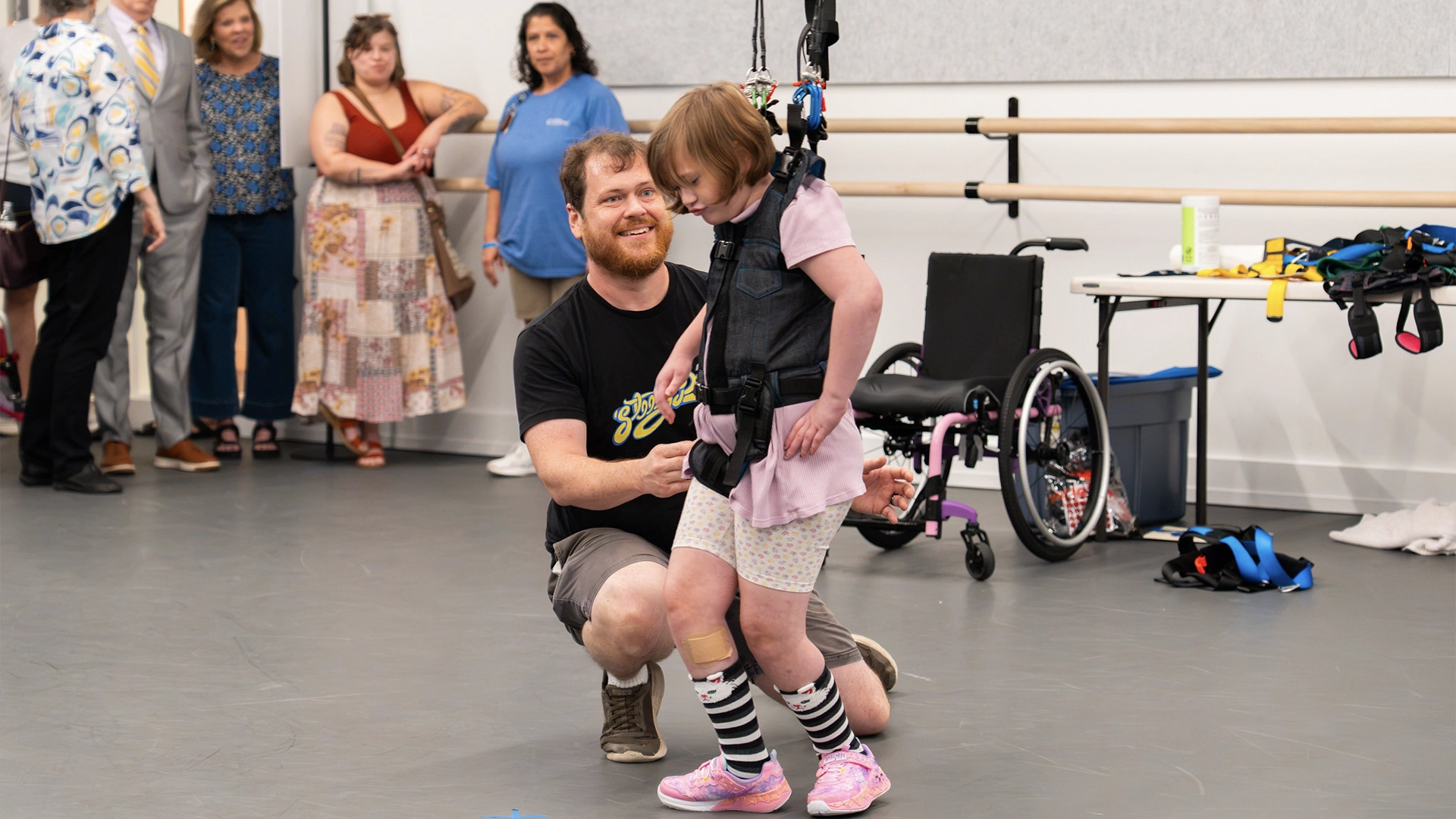 Student trying on a harness with our new adaptive harness system