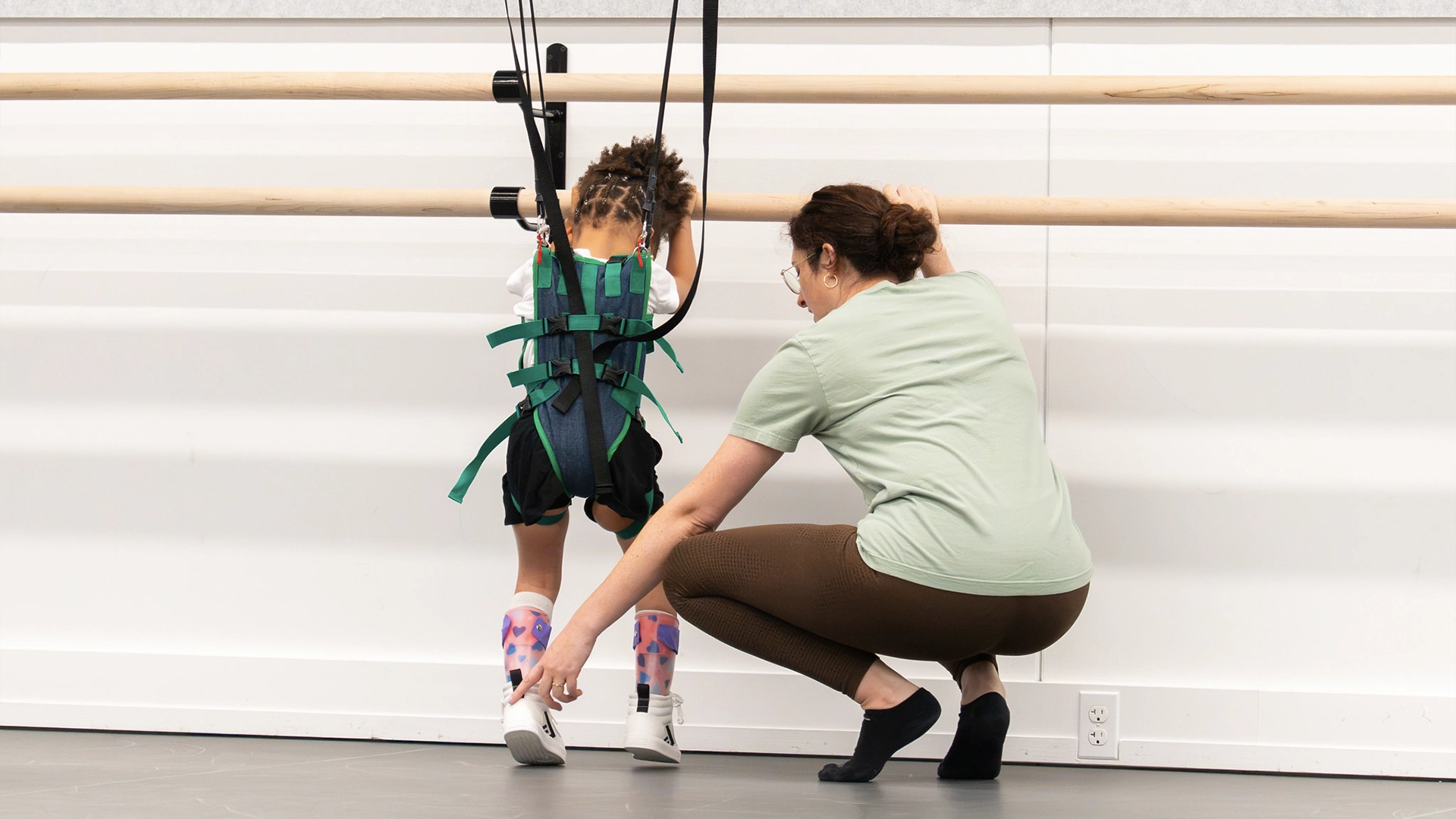 Student trying on a harness with our new adaptive harness system